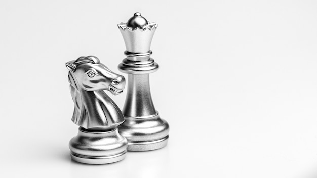 Silver horse and queen chess standing. - Business winner and fight concept.