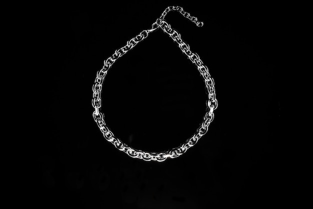 Silver jewelry chain isolated on black background.