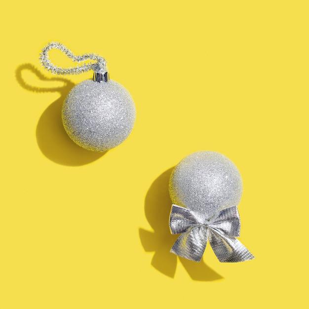 Silver New years balls holiday toy Christmas card Trend color of 2021 year yellow and ultimate gray