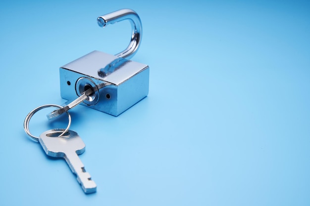 Silver padlock against blue background