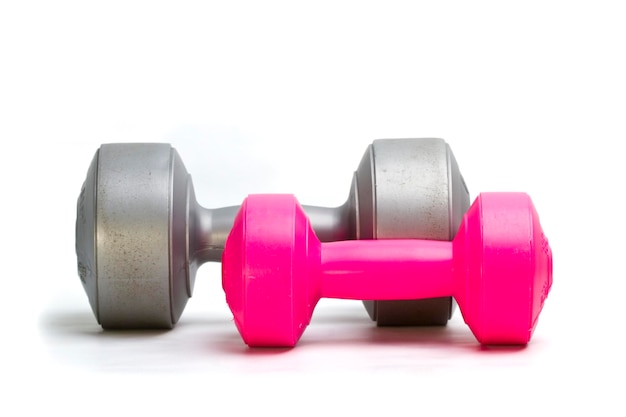 Silver and pink dumbbells isolated on white background