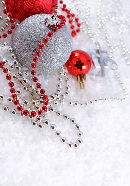 Silver and red Christmas decorations on a white background