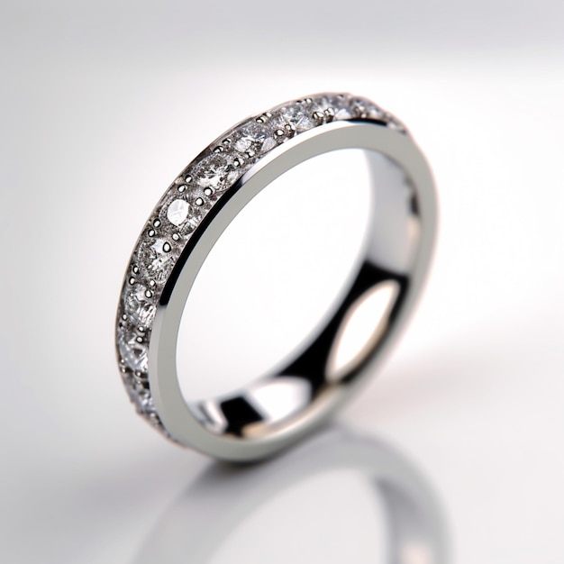 A silver ring with diamonds on it is laying on a table.