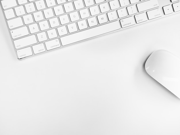 Silver smart keyboard and wireless mouse electronic device top view isolated on white desk