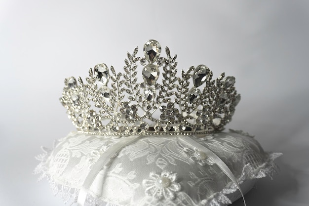 A silver tiara with a silver crown on it.