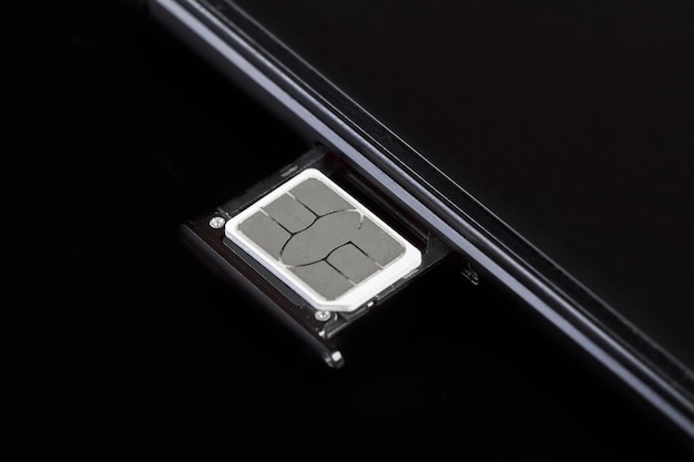 SIM card inserted into the sim card tray of a smartphone