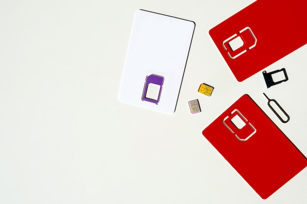 SIM card slot white background red gsm phone copy space