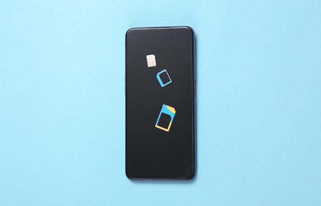 Sim card with smartphone on blue background