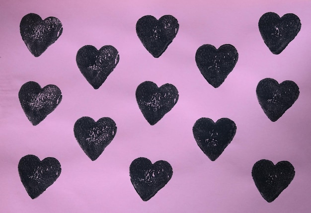 simple black hearts on pink paper pattern