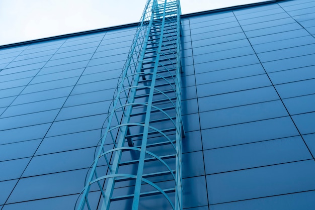 A simple building outdoors, fire escape ladder, emergency exit