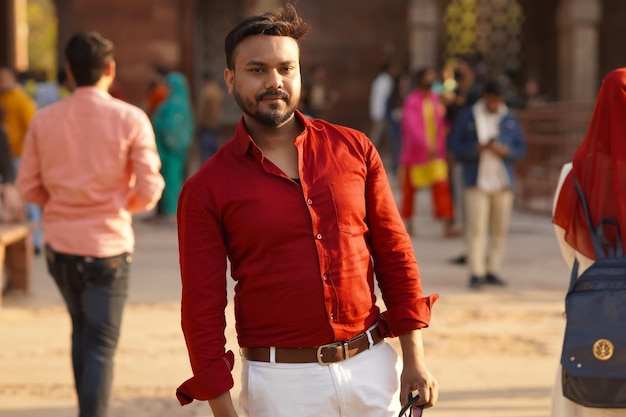 A simple Indian man in red shirt and white pant