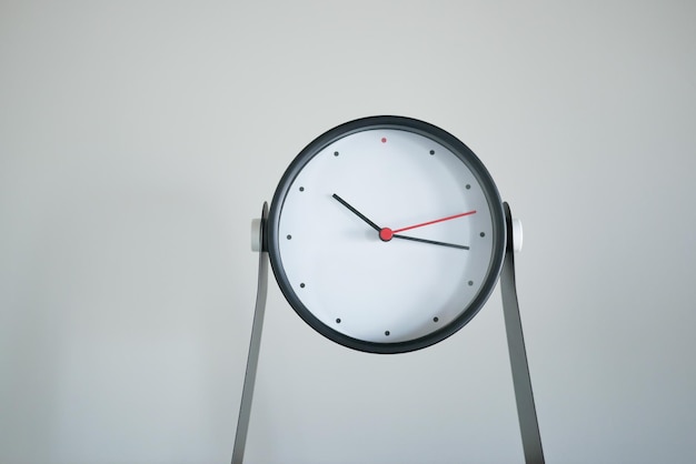 Simple modern clock against white wall