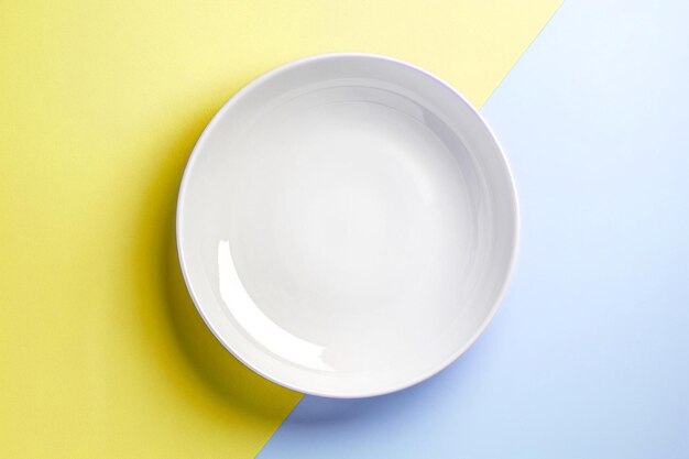 Simple plain white plate colorful background flat lay Top view empty clean dish pastel colors