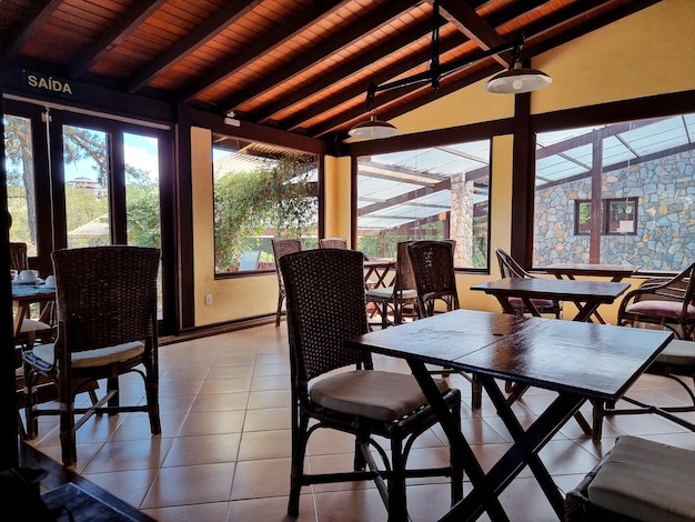 Simple restaurant interior with wooden tables and chairs