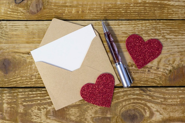 Simple small envelope with space for writing on wooden background with pen Narrow focus line shallow depth of field