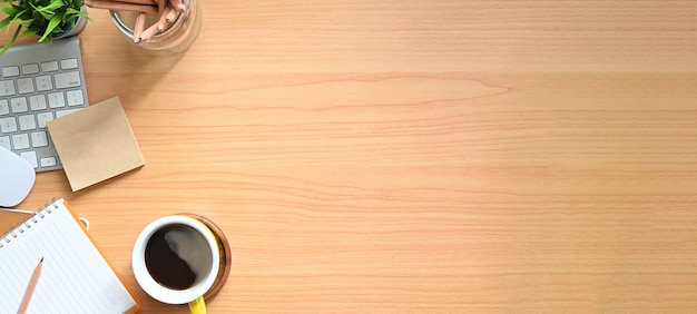 Simple Top view wood table - Creative flat lay office desk. Laptop, notebooks and coffee cup on wooden background.