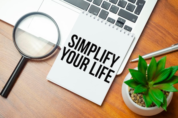 Simplify Your Life writing text post it paper in office on laptop computer keyboard