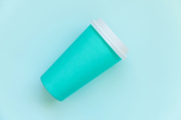 Simply flat lay design blue paper coffee cup on blue pastel colorful trendy background