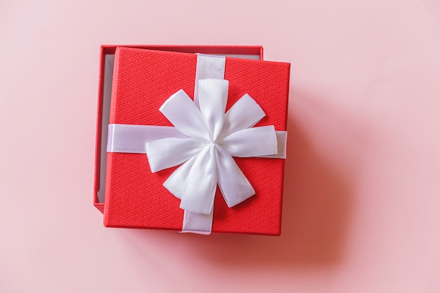 Simply minimal design red gift box isolated on pink background