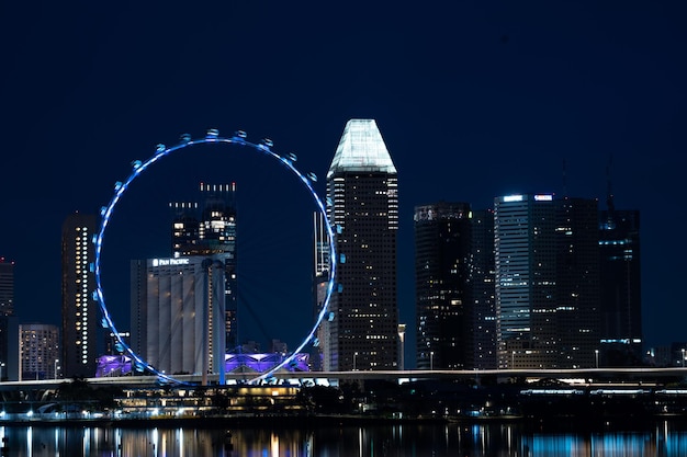 Singapore city skyline with modern skyscraper architecture building for concept of financial business and travel in Asia cityscape urban landmark marina bay at night district dusk sky