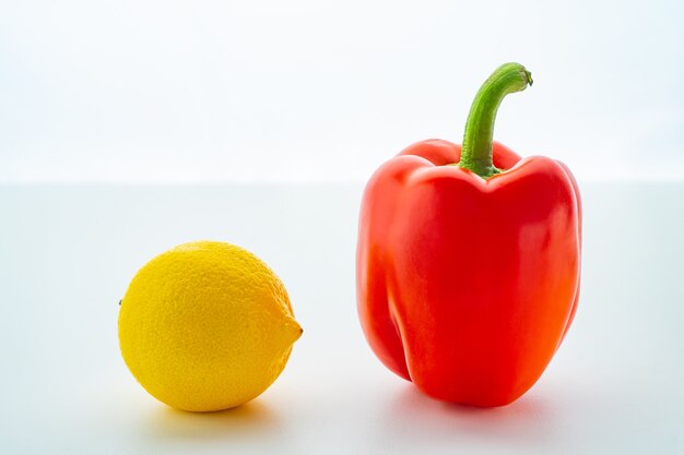 Single Bell pepper and lemon isolated on white background.