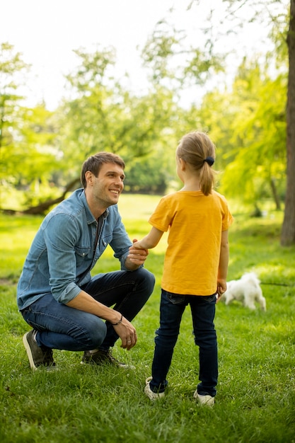 Single father in the park with his cute little daughter