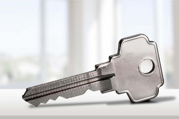 Single house key on apartment background