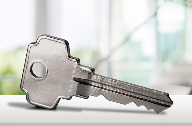 Single house key isolated on background