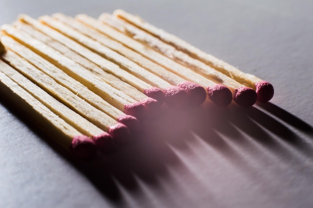 Single match protruding from matchboxCloseup shotCloseup of pink match heads