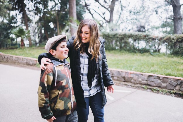 Single mother with her young son walking in the park Single parent family