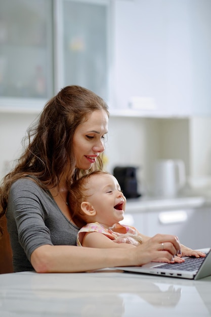 Single Mother Working on Laptop