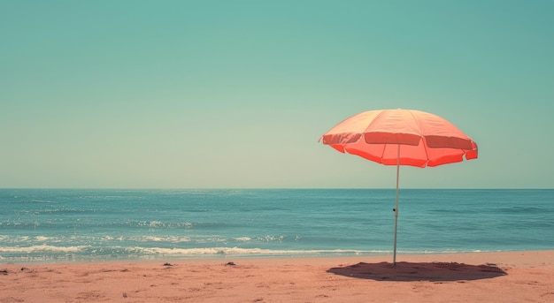 A Single Orange Beach Umbrella Stands Alone on a Sandy Shore