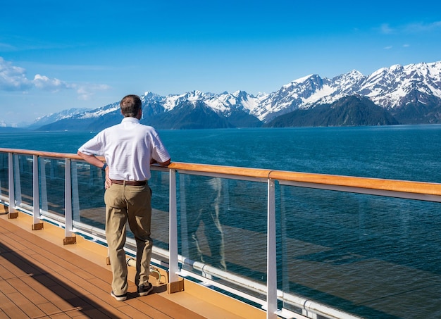 Single senior man on deck as cruise ship departs from Seward