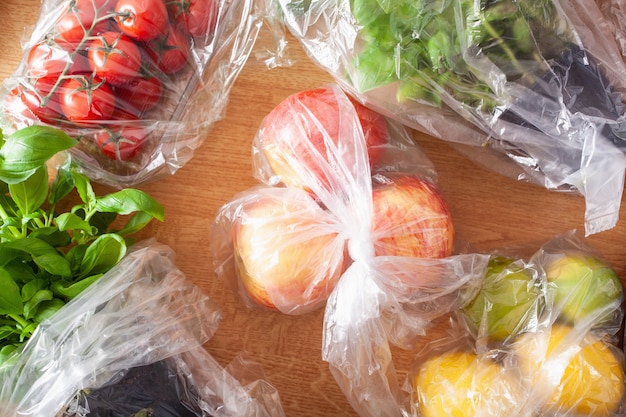 Single use plastic waste issue. fruits and vegetables in plastic bags