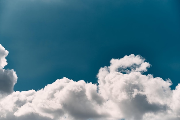 Single white cloud in the blue sky Background texture of a summer sky