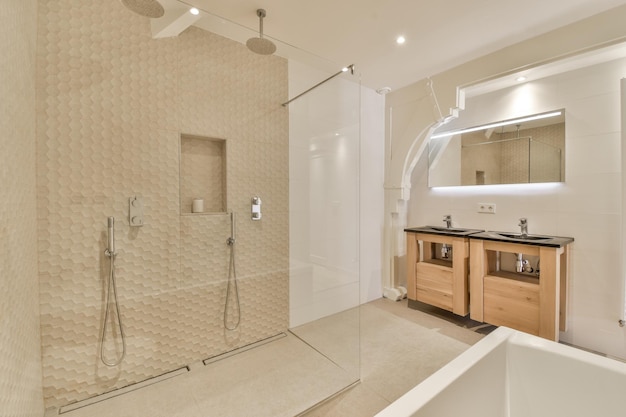 Sinks and bathtub near shower cabin