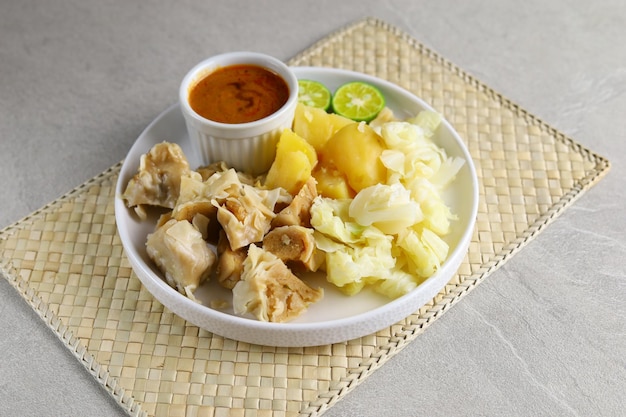 Siomay Bandung. Fish cake dumplings with potato and cabbage roll served with peanut  sauces