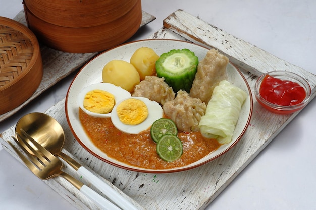 siomay or Somai,Indonesian steamed fish dumpling with vegetables served in peanut sauce.