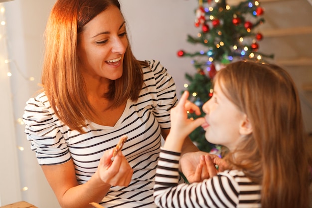 Sister baking chocolate cookies at christmas time