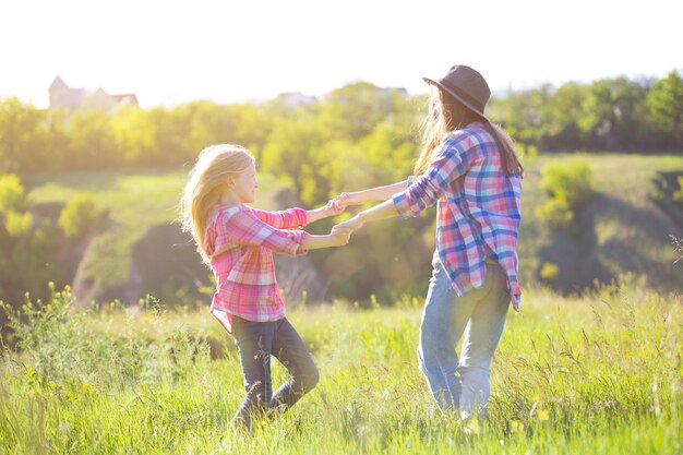 Sister girls having fun in the meadow