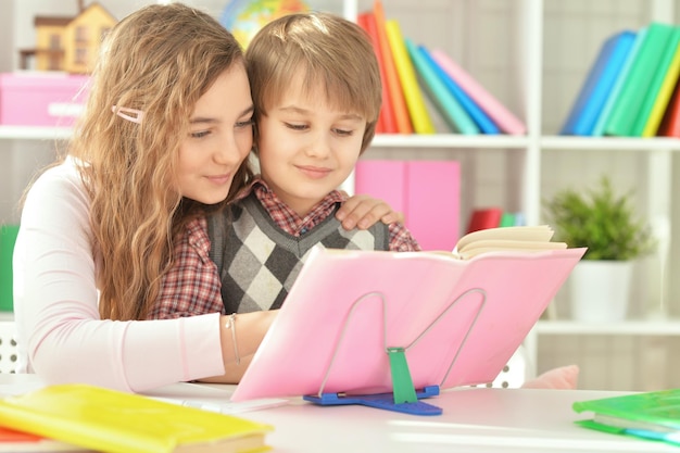 Sister helping her brother with homework