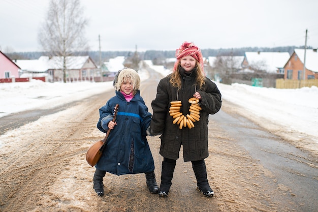 Sisters standing on the road with balalaika