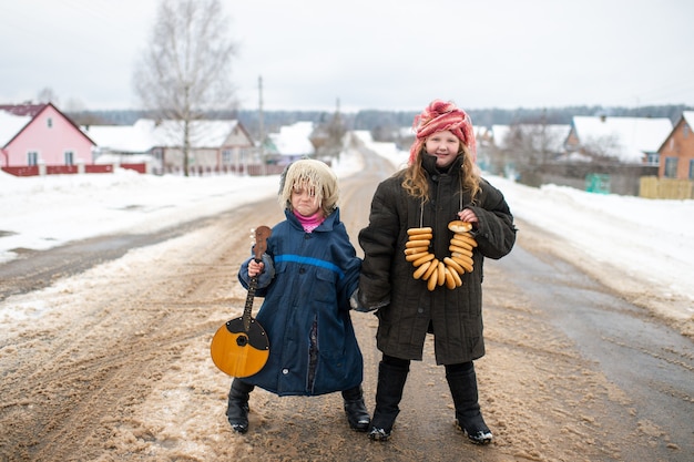 Sisters standing on the road with balalaika