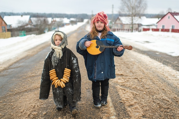 Sisters standing on the road with balalaika