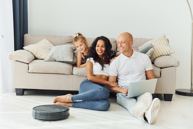 Sitting on the floor Cheerful couple is together indoors