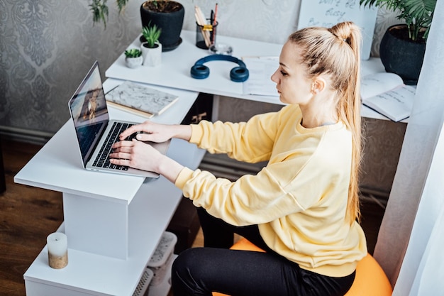 Sitting on gym ball at work use exercise ball like chair at workplace freelancer woman sitting on