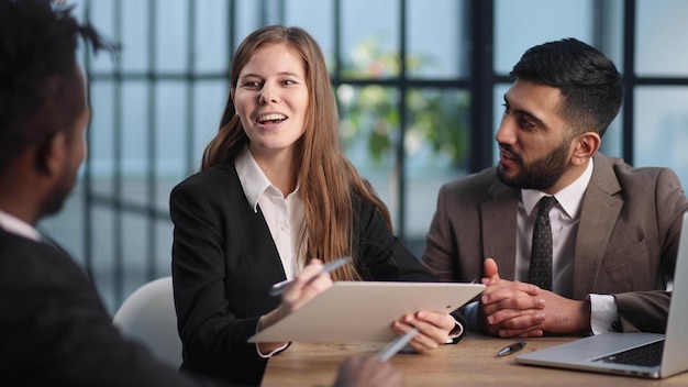 Sitting at the table young business people working in the office