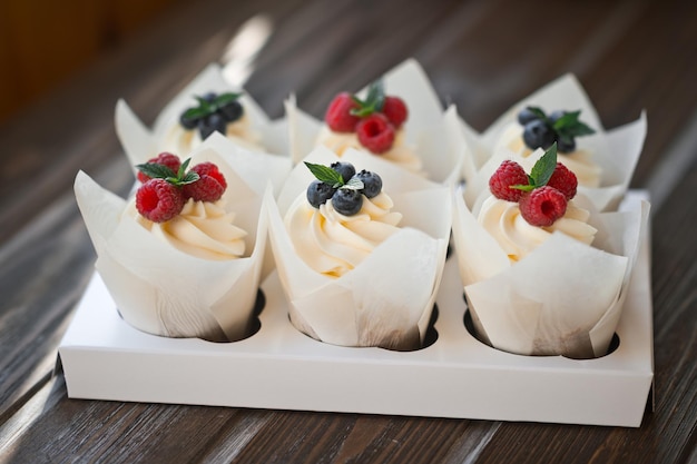 Six cream cakes decorated with berries on a stand 3623