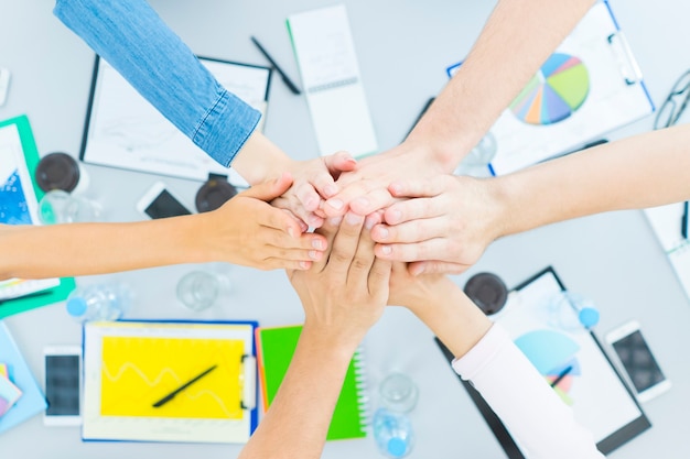 The six people gesture at the desktop. view from above