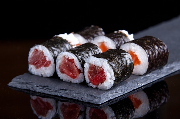 Six tuna makis on slate tray